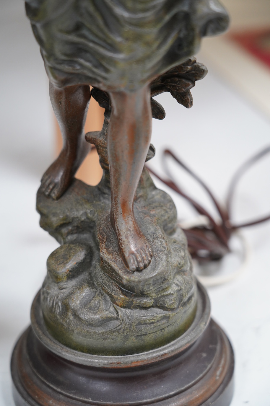 After Guillemin (1841-1907), a pair of spelter figural lamps with frosted glass shades, overall 61cm high. Condition - poor to fair, damage to glass